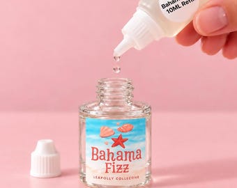 May include: A clear plastic squeeze bottle with a white cap and a label reading Bahama Fizz 10ML REFILL. A second clear glass bottle features a label with a beach scene, a red starfish, and the text Bahama Fizz LEAPOLLY COLLECTIVE.
