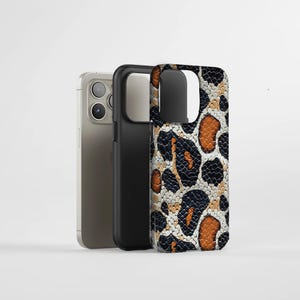 May include: Three phone cases. One is light grey, one is black, and the third has a leopard print design in black, brown, and tan. The cases are standing upright against a white background.