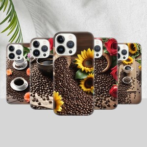 May include: A collection of phone cases with coffee-themed designs. Each case features a different arrangement of coffee beans, cups, and floral accents like sunflowers and roses. The cases have a wooden background.