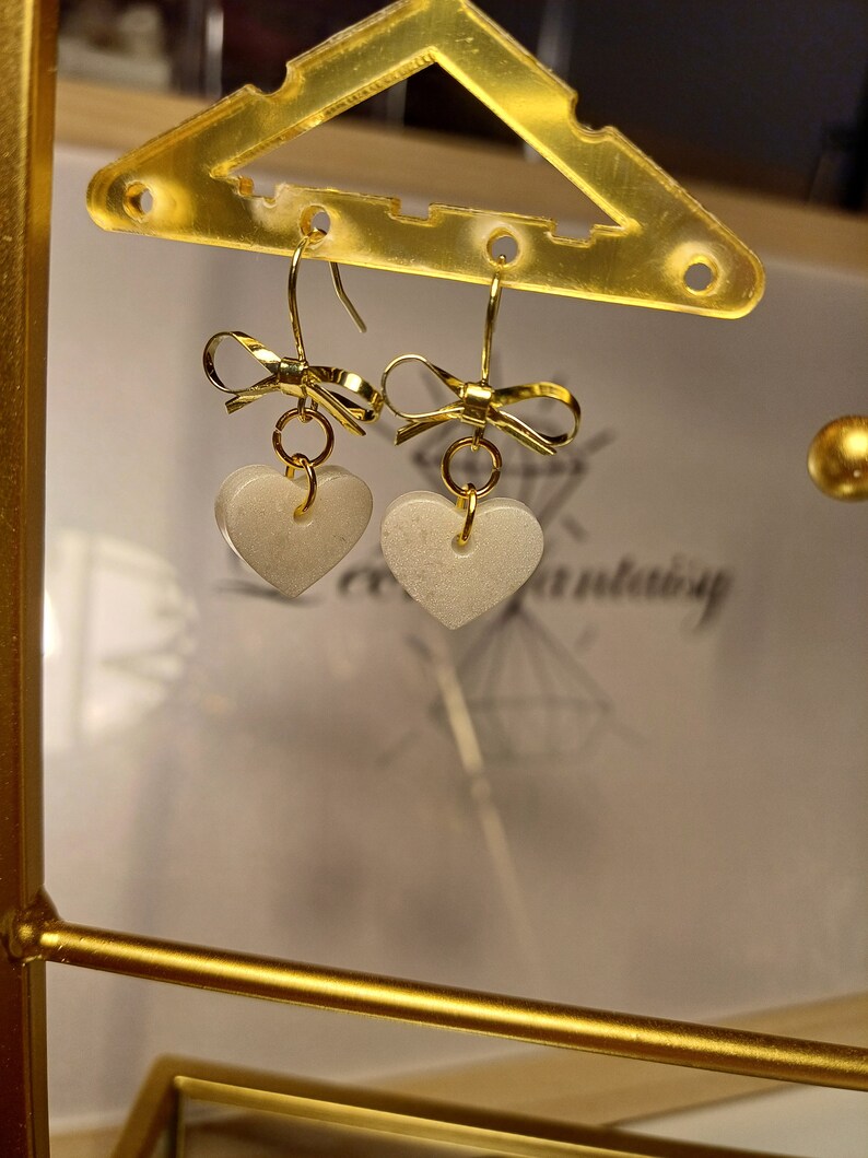 Boucles d'oreilles nœud Blanc irisé