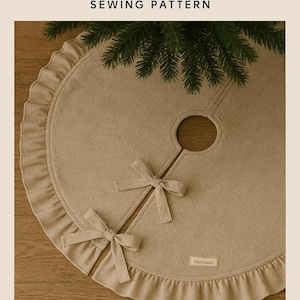 May include: A beige herringbone plaid Farmhouse Tree Skirt sewing pattern. The skirt has a ruffled edge, two bows, and a circular opening for the tree trunk. The text "handmade" is on a small label. The text "HERRINGBENE PLAID" is at the bottom.