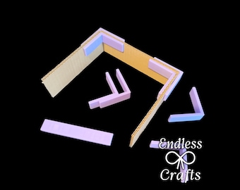 May include: A set of five cardboard corner protectors with a light blue and purple color scheme. The protectors are designed to protect corners from damage. The protectors are arranged in a pattern on a black background. The text "Endless Crafts" is visible in the lower right corner of the image.