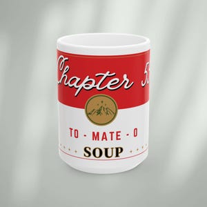 May include: White ceramic mug with a red and white design that looks like a can of soup. The can says "Chapter 5" and "To-Mate-O Soup".