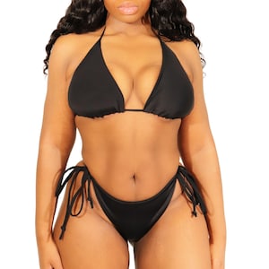 May include: Black bikini with a triangle top and a high-cut bottom with ties on the sides.