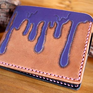 Handcrafted leather wallet with hand-painted purple paint detail