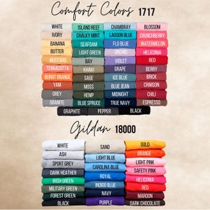 May include: A display of folded t-shirts in various colors, including white, blue, and pink. The image features two sections, one labeled "Comfort Colors 1717" and the other "Gildan 18000", each showcasing a range of available hues for apparel.