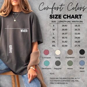 May include: A size chart for Comfort Colors t-shirts is displayed, with measurements in inches for sizes S through 3XL. The chart includes length and width dimensions. Color swatches include Crimson, Ivory, Espresso, Black, Seafoam, Pepper, Moss, and Blue Jean.