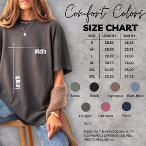May include: A dark gray t-shirt with a size chart and color options. The size chart lists measurements in inches for sizes S through 3XL. Color options include Moss, Black, Espresso, Blue Jean, Pepper, Crimson, and Navy.