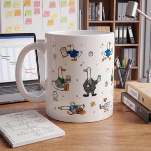 May include: A white ceramic mug featuring a repeating pattern of cartoon ducks dressed in business attire, holding items like briefcases, coffee cups, and smartphones, interspersed with small star icons and office-related symbols.
