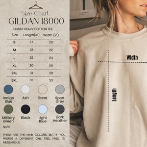 May include: A size chart for a Gildan 18000 unisex heavy cotton tee. The chart shows sizes S to 3XL with length and width measurements in inches. Color options include Indigo Blue, Ash, Sand, Sport Grey, Military Green, Black, Light Blue, and Dark Heather.
