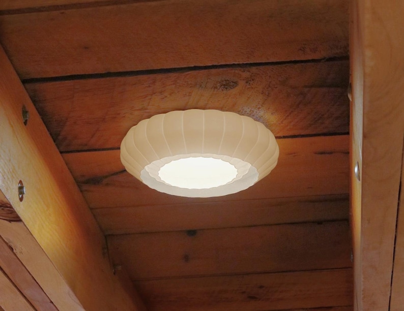 This is a white, 3d printed light shade that mounts onto 6 inch recessed lights. It diffuses the light beautifully, changing the harsh overhead light of recessed lighting into a soft glow, and provides a beautiful decorative touch as well. It has an elegant, scalloped edge and which has floral feeling to it. No hardware is needed to install the light, it comes with easy-to-install tabs that make install or changing a bulb simple.