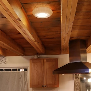 This is a white, 3d printed light shade that mounts onto 6 inch recessed lights. It diffuses the light beautifully, changing the harsh overhead light of recessed lighting into a soft glow, and provides a beautiful decorative touch as well. It has an elegant, scalloped edge and which has floral feeling to it. No hardware is needed to install the light, it comes with easy-to-install tabs that make install or changing a bulb simple.