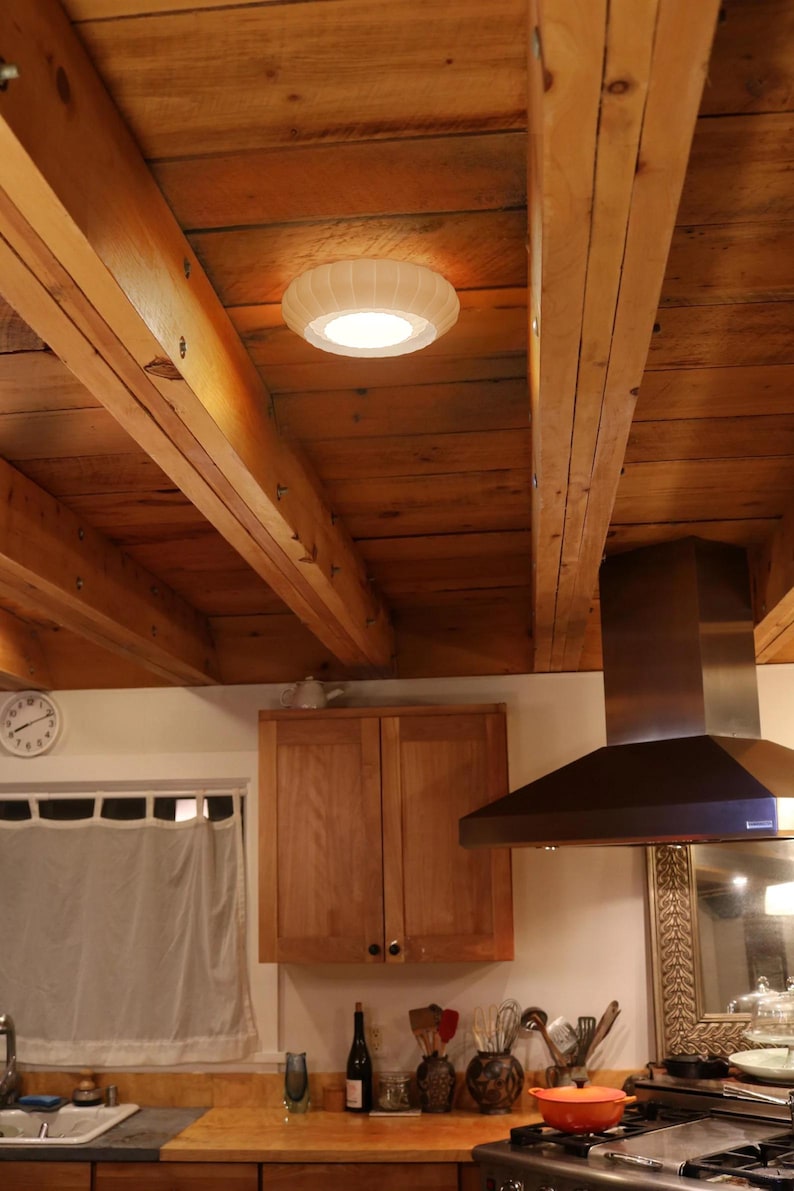 This is a white, 3d printed light shade that mounts onto 6 inch recessed lights. It diffuses the light beautifully, changing the harsh overhead light of recessed lighting into a soft glow, and provides a beautiful decorative touch as well. It has an elegant, scalloped edge and which has floral feeling to it. No hardware is needed to install the light, it comes with easy-to-install tabs that make install or changing a bulb simple.