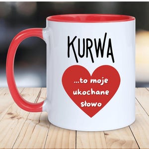 May include: White ceramic mug with a red rim and handle. The mug has a black graphic that says "KURWA...to moje ukochane slowo" with a red heart.