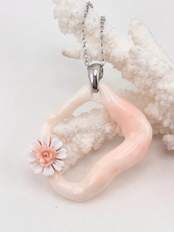 Pendant with natural shape of pink coral from Asian seas, hand-engraved flower cameo on shell, mounted in 925 silver