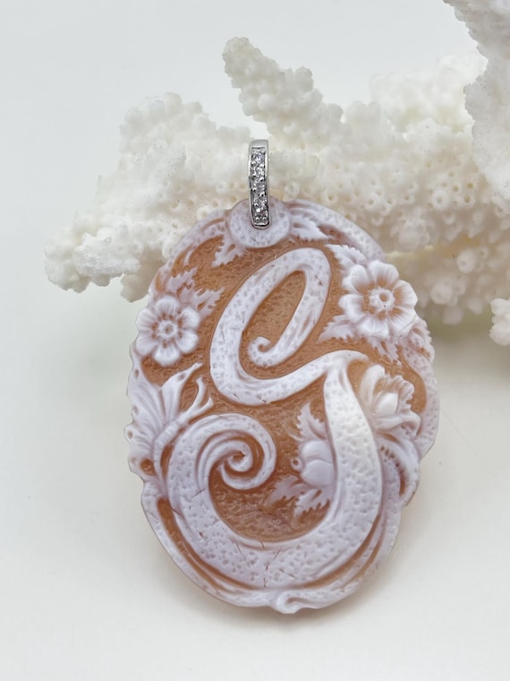 Cameo letter “G” engraved on Cassis Madagascariens shell mounted in 925 silver and zircons