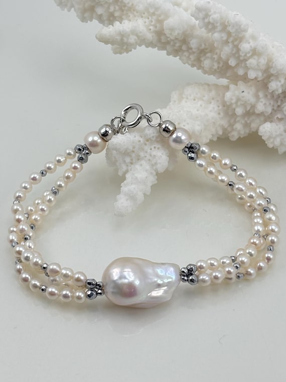 Bracciale con PERLA BAROCCA e perle coltivate d’acqua dolce provenienti dall’Asia, sfere in ematite grigia e montatura in ARGENTO 925