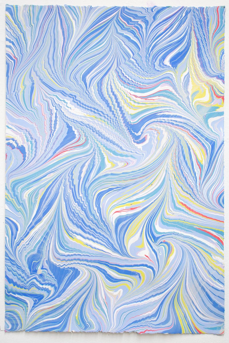 May include: Abstract artwork featuring a swirling pattern of blue, white, yellow, and red lines. The design resembles flowing water or marbled paper. The artwork is on a white background.