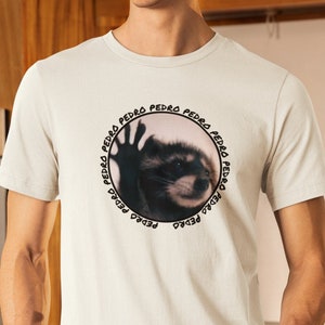 Pedro Raccoon Unisex Meme T-Shirt, Stylish Viral Animal Tee, Urban Wildlife Enthusiast Gift, Internet Meme Casual Wear Bild 1