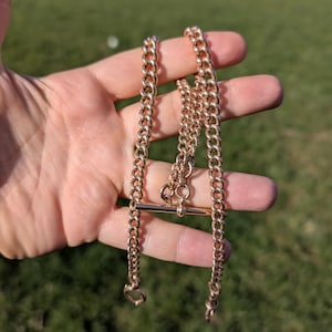 9k rosey gold watch chain slightly graduated link wearable length, links hallmarked, likely antique