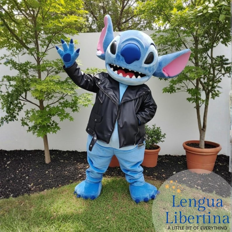 May include: A blue character costume with large ears, a black leather jacket, and blue pants. The character is waving with a blue hand. The costume has a large, toothy grin. The text "Lengua Libertina" is in the bottom right corner.