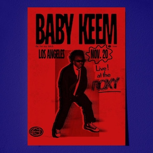 May include: A red and black concert poster for Baby Keem's Los Angeles show at The Roxy on November 20th. The poster features a black and white image of a person in a suit and sunglasses.