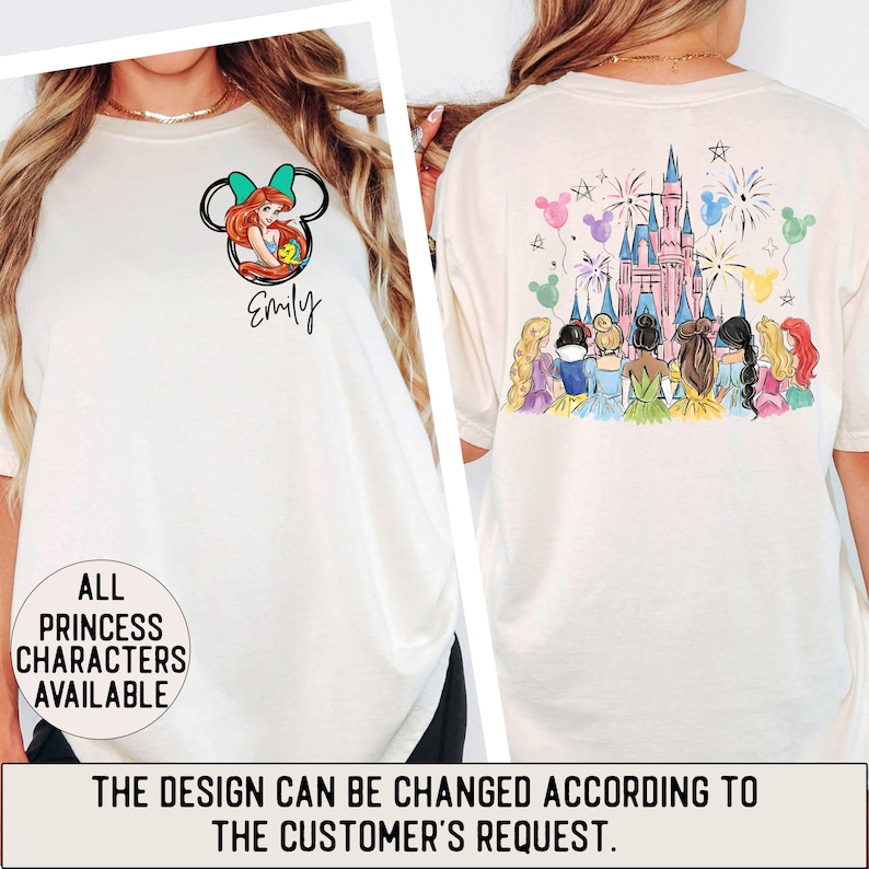 May include: Cream-colored t-shirt featuring a cartoon of Ariel in a Mickey Mouse silhouette, with the name "Emily" below. The back of the shirt displays a castle with fireworks and princess characters. Text on the shirt reads "ALL PRINCESS CHARACTERS AVAILABLE".