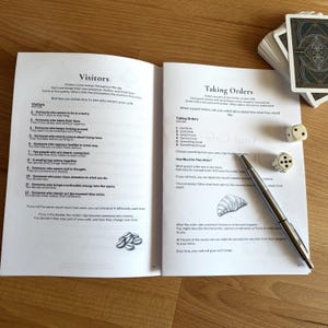 Inside pages of a cozy café journaling game showing rules and gameplay