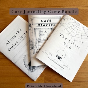 May include: Three softcover books with black and white illustrations and text. The titles are "Along the Quiet Shore", "Café Stories", and "The Little Web". The text "Cozy Journaling Game Bundle" and "Printable Download" are also visible.