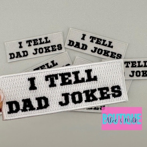 May include: Five white iron-on patches with black text that reads "I tell dad jokes".