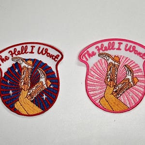 May include: Embroidered patches with the phrase "The Hell I Won't" and a cowboy boot design. One patch has a red border with a blue and red burst background, the other has a pink border and background.