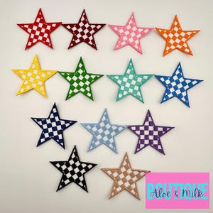 May include: Twelve iron-on patches in the shape of a star with a checkered pattern. The patches are in various colors, including red, pink, orange, yellow, green, blue, purple, and black. The patches are all the same size and have a white background with black squares.