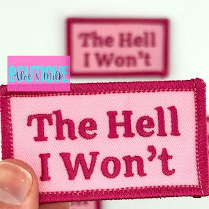 May include: Pink fabric patch with pink stitching around the edges. The patch has the text "The Hell I Won't" in a bold, pink font.