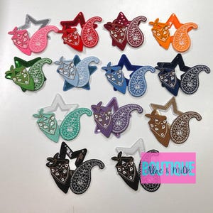 May include: Assortment of 12 colorful paisley and star-shaped iron-on patches. The patches feature a variety of colors, including red, blue, green, purple, and black. The patches are perfect for adding a touch of personality to clothing, bags, or other accessories.