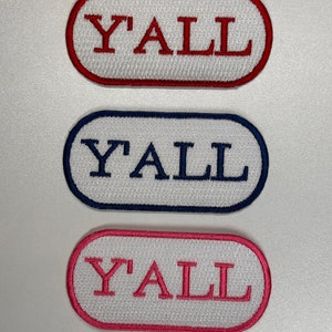 May include: Three embroidered iron-on patches with the word "Y'ALL" in red, blue, and pink lettering on a white background.