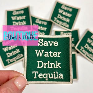 May include: A set of green and white iron-on patches with the text "Save Water Drink Tequila".