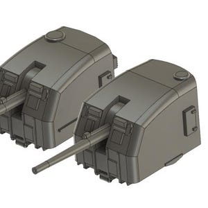 Könnte beinhalten: Zwei graue Metallmodelle von Geschütztürmen mit nach vorne gerichteten Läufen. Die Türme sind mit erhabenen Linien und einer kleinen Luke oben detailliert.
