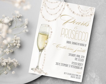 May include: A white bridal shower invitation with gold text that reads "Pearls & Prosecco". The invitation features a watercolor illustration of a champagne flute with pearls cascading down the glass. The text also includes the bride's name, the date and time of the shower, the location, and the RSVP information.