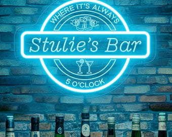 May include: A neon sign that reads "Stulie's Bar" with the text "Where it's always 5 O'Clock" above a row of liquor bottles. The sign is blue and the background is a brick wall.