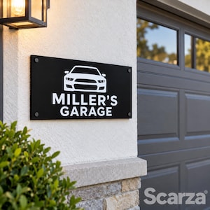May include: A rectangular black sign mounted on a white wall featuring a white graphic of a sports car above the white text MILLER'S GARAGE. The sign is secured with four silver circular fasteners at each corner of the flat surface.