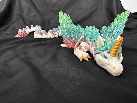 Fully articulated 3D-printed alicorn dragon that actually flexes and poses — a tactile fantasy collectible that's weirdly satisfying to handle.