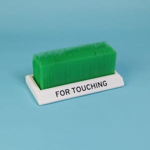 Touch Grass desk toy white base green bristles funny office accessory