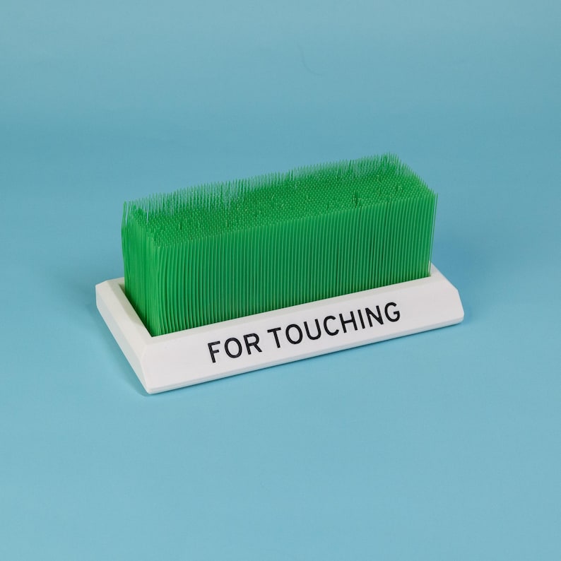 Touch Grass desk toy white base green bristles funny office accessory