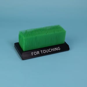 Touch Grass desk toy black base green grass bristles coworker gift