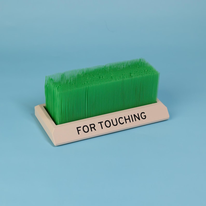 Touch Grass desk toy beige base green bristles quirky office decor