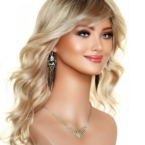 May include: A blonde wig with loose curls and a side part. The wig is styled with a fringe and has a natural-looking finish.