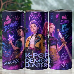 May include: Three stainless steel tumblers with a K-Pop theme. Each tumbler features a different anime-style illustration of a woman with text that reads "We Hunt Demons", "K-Pop Demon Hunters", and "We Sing We Slay". The tumblers have a purple and pink color scheme.