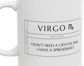 May include: A white ceramic mug featuring a black graphic design. The text reads VIRGO with the zodiac symbol, AUG 23 - SEP 22, and the phrase I DON'T NEED A CRYSTAL BALL I HAVE A SPREADSHEET. The words ZODIAC COLLECTION are printed vertically.