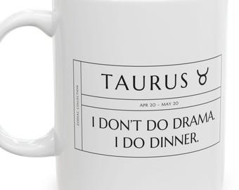May include: A white ceramic mug featuring a black rectangular graphic with the text TAURUS, the Taurus zodiac symbol, the dates APR 20 - MAY 20, and the phrase I DON'T DO DRAMA. I DO DINNER. The text ZODIAC COLLECTION is printed vertically.