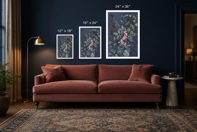 May include: Three rectangular wall art prints featuring a dark blue background with green foliage and pink flowers. The prints are labeled with dimensions of 12" x 18", 16" x 24", and 24" x 36" respectively, displayed in white frames.